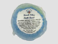 Blue and green bath bomb with a label on a white background