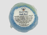 Blue and green bath bomb with a label on a white background