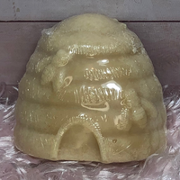 Beehive shaped hand soap displayed upright on pink background