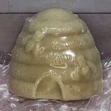 Beehive shaped hand soap displayed upright on pink background