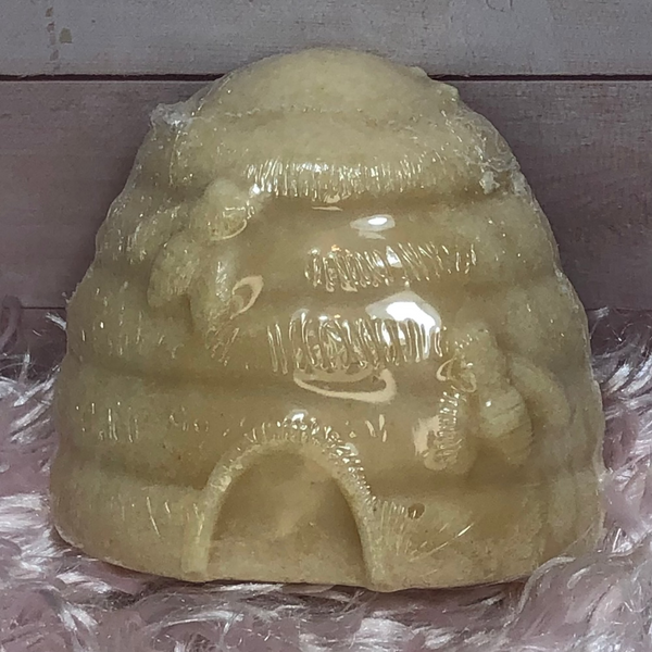 Beehive shaped hand soap displayed upright on pink background