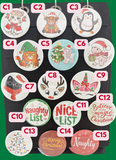 Collection of Christmas-themed pinback buttons on a display card with labels.
