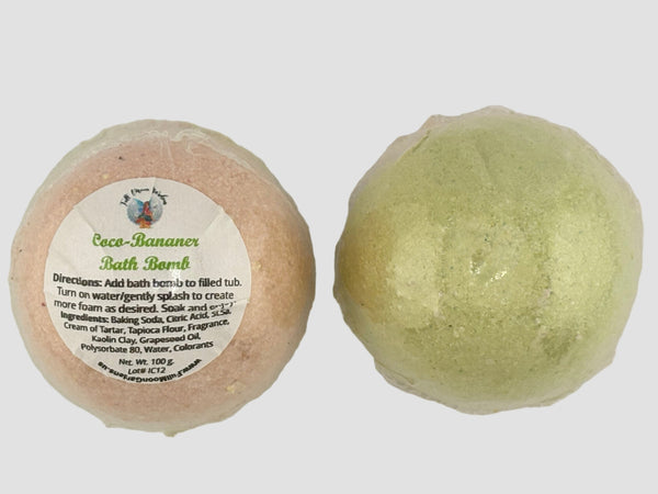 Two bath bombs, one pink and one green, on a light gray background.