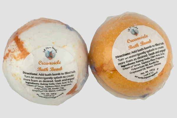 Two bath bombs with labels on a white background
