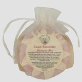 Full Moon Gardens Soapery concentrated solid Shampoo bar in a white organza drawstring bag with a label on a white background